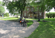 motorcyle parked in front of old stone building
